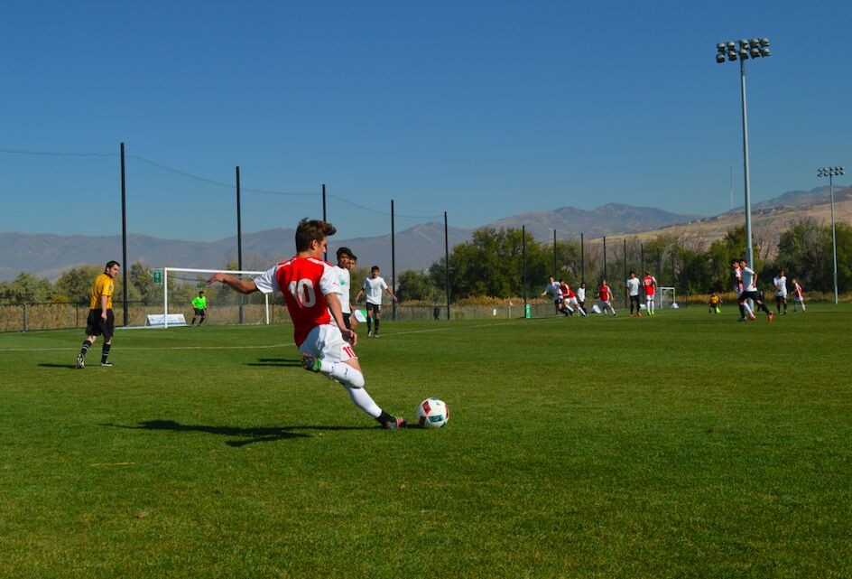 Ethan Harris striking a soccer ball in a match